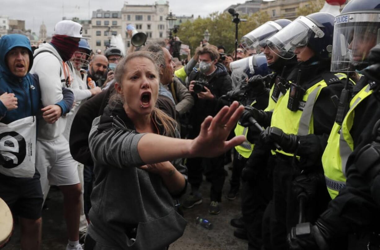 Riot police face protesters who took part in a &#039;We Do Not Consent&#039; rally at Trafalgar Square, organised by Stop New Normal, to protest against coronavirus restrictions, in London, Saturday, Sept. 26, 2020.