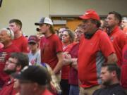 People wear red in solidarity against a potential city-wide mask mandate during a city council meeting on Wednesday, Sept. 2, 2020, in Brookings, S.D. Coronavirus infections in the Dakotas are growing faster than anywhere else in the nation, fueling impassioned debates over masks, personal responsibility and freedom after months in which the two states avoided the worst of the pandemic.