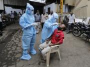 A health worker takes a nasal swab sample to test for COVID-19 in Ahmedabad, India, Friday, Sept. 11, 2020. India&#039;s coronavirus cases are now the second-highest in the world and only behind the United States.