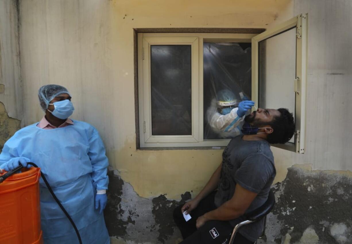 A health worker takes a nasal swab sample to test for COVID-19, as another waits to sanitize the area in New Delhi, India, Saturday, Sept. 5, 2020. India&#039;s coronavirus cases have crossed 4 million, leading the world in new infections and deepening misery in the country&#039;s vast hinterlands where surges have crippled the underfunded health care system. Initially, the virus ravaged India&#039;s sprawling and densely populated cities. It has since stretched to almost every state, spreading through villages.