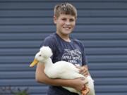 Payne Steffan poses for a photo with his duck, Arlo, Tuesday, Sept. 1, 2020, near Jenera, Ohio. Steffan is sad he won&#039;t get to show off his ducks or get to impress the judges with how much he knows. The Hancock County Fair was cancelled due to the coronavirus.