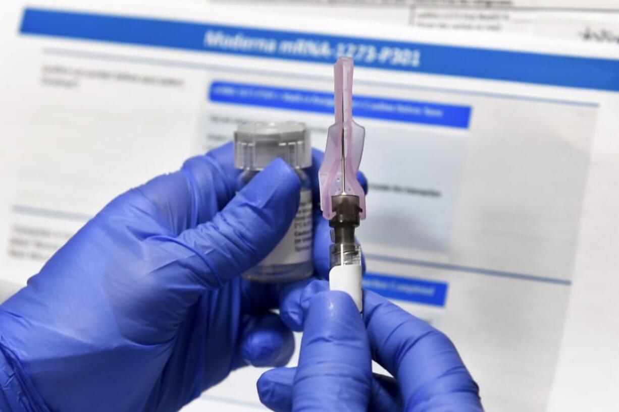 FILE - In this Monday, July 27, 2020 file photo, a nurse prepares a shot as a study of a possible COVID-19 vaccine, developed by the National Institutes of Health and Moderna Inc., gets underway in Binghamton, N.Y. On Tuesday, Sept. 8, 2020, the top executives of nine drugmakers likely to produce the first vaccines against the new coronavirus said that they will stick to the highest ethical and scientific standards in testing and manufacturing and will make the well-being of those getting vaccinated their top priority.