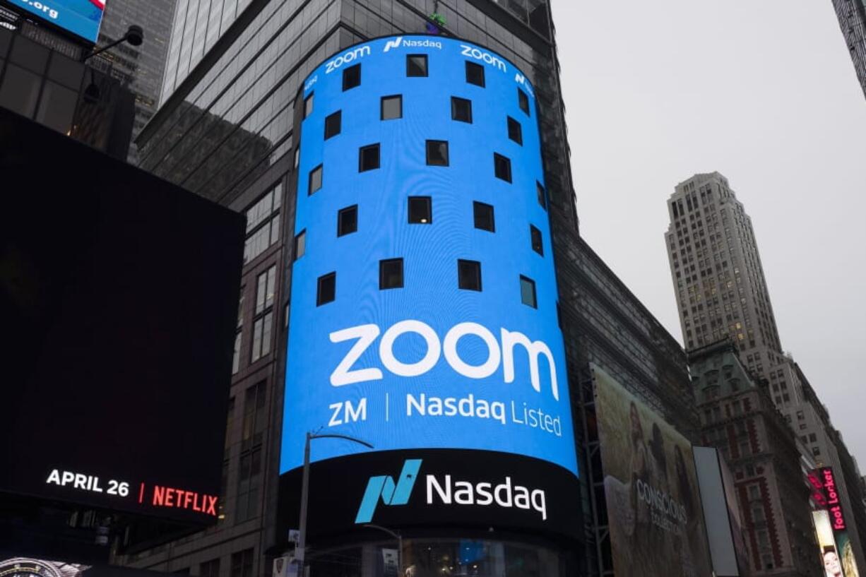 FILE - This April 18, 2019, file photo shows a sign for Zoom Video Communications ahead of the company&#039;s Nasdaq IPO in New York. Zoom&#039;s videoconferencing service is deepening its integral role in life during the coronavirus pandemic as tens of thousands more businesses and other users pay for subscriptions to get more control over their virtual meetings. The surge in paying customers enabled Zoom to hail another quarter of astounding growth in a report released Monday, Aug. 31, 2020.