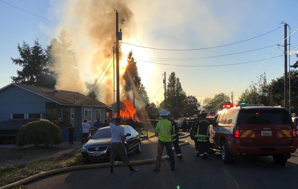 Responding personnel stay back during a chaotic fire scene in Vancouver's Hough neighborhood.