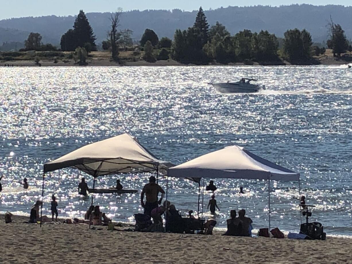 Crowds flocked to Frenchman's Bar Regional Park on the Columbia River during a windy Sunday as temperatures approached 90 degrees. The National Weather Service predicts a high of 91 degrees Monday and a potentially "historic" wind event, with gusts up to 55 miles per hour.