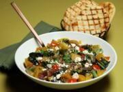 Grilled golden beets center a fall salad that makes a colorful dinner, with sauteed beet greens, red onions, bell pepper, herbs and crumbled feta.