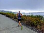 Rolf Vellek of Vancouver runs along the Columbia River on the marked course for the PeaceHealth Apple Tree Half Marathon last month.