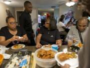 Della Frazier and Zsaneen Kennedy, mother and daughter, both survivors of breast cancer, have a twice-monthly dinner with family members at the Kennedy home last year. Kennedy told her family about her breast cancer diagnosis at a family dinner like this in 2018.