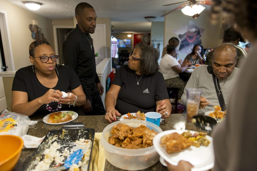 Della Frazier and Zsaneen Kennedy, mother and daughter, both survivors of breast cancer, have a twice-monthly dinner with family members at the Kennedy home last year. Kennedy told her family about her breast cancer diagnosis at a family dinner like this in 2018.