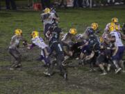 Columbia River and Hockinson play through muddy conditions late in the fourth quarter at Hockinson High School on Friday night, Oct. 14, 2016.