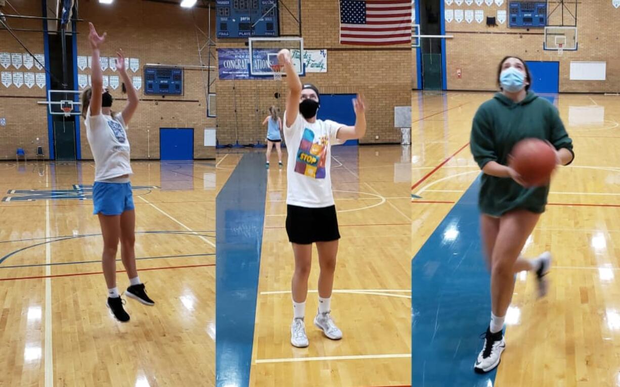 Mountain View girls basketball players Lauren DeLargy (left), Nina Peterson (center) and Ella Schoene (right) go through individual workouts this week in the Mountain View gym.