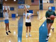 Mountain View girls basketball players Lauren DeLargy (left), Nina Peterson (center) and Ella Schoene (right) go through individual workouts this week in the Mountain View gym.