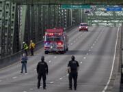 First responders keep an eye on the scene as police work on the Interstate Bridge as lanes are cleared of traffic on Tuesday morning, Oct. 20, 2020.