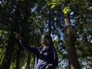 Elizabeth Koch of Vancouver, who is a cancer survivor, points out some of her favorite areas in Jorgenson Woods Neighborhood Park. Koch believes in the therapeutic power of nature and forests.