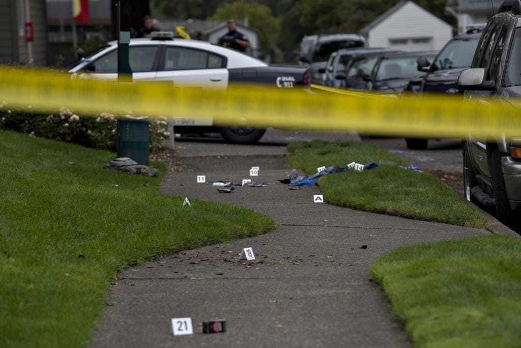 Evidence is marked as officials work at the scene after a domestic violence investigation resulted in a fatal police shooting in Vancouver's Rose Village neighborhood on Oct. 4.