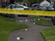 Evidence is marked as officials work at the scene after a domestic violence investigation resulted in a fatal police shooting in Vancouver's Rose Village neighborhood on Oct. 4.