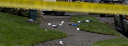 Evidence is marked as officials work at the scene after a domestic violence investigation resulted in a fatal police shooting in Vancouver's Rose Village neighborhood on Oct. 4.