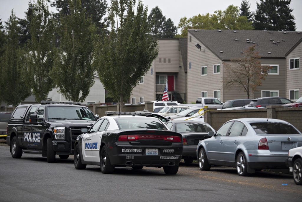 Police work at Parc Central Apartments in Vancouver's Rose Village neighborhood on Monday morning, Oct. 5, 2020.