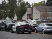 Police work at Parc Central Apartments in Vancouver's Rose Village neighborhood on Monday morning, Oct. 5, 2020.