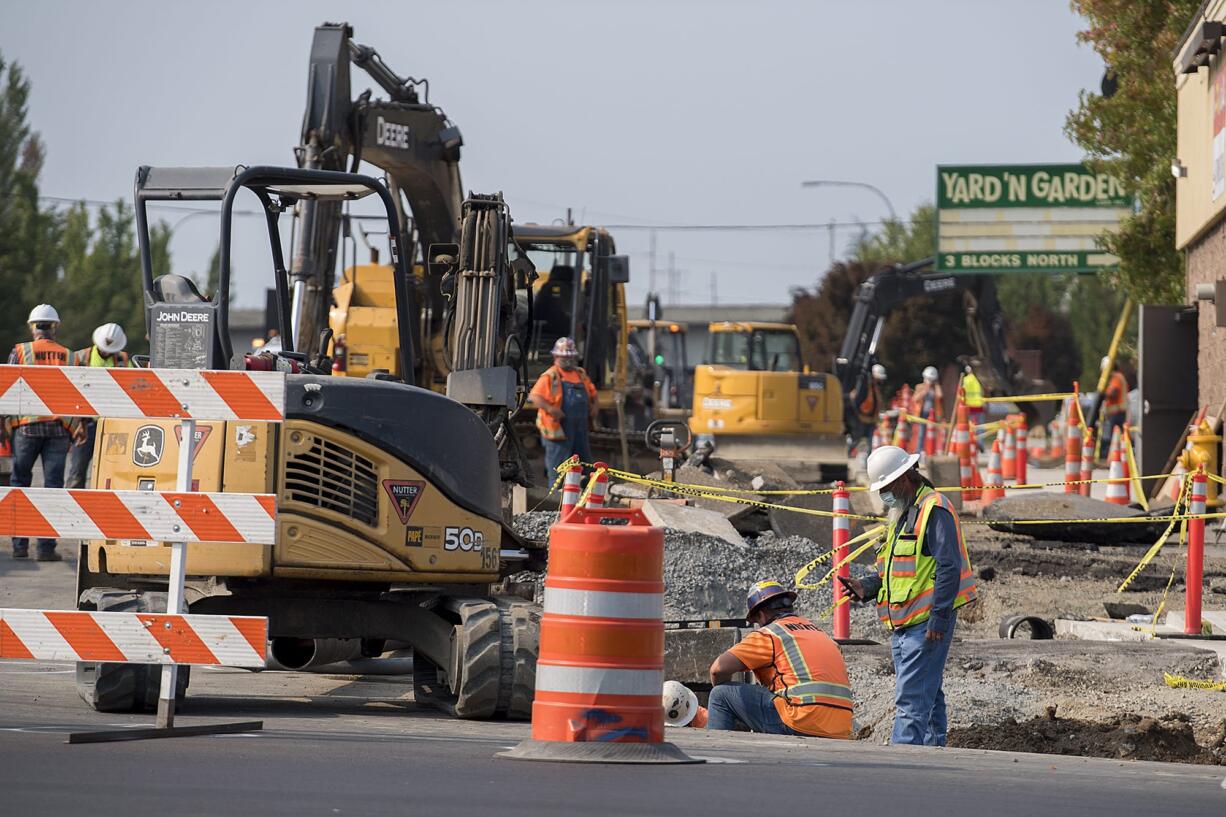 Construction workers tackle a big road project at the intersection of Northeast Highway 99 and Northeast 99th Street in Hazel Dell on Wednesday afternoon.