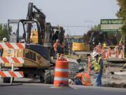 Construction workers tackle a big road project at the intersection of Northeast Highway 99 and Northeast 99th Street in Hazel Dell on Wednesday afternoon.