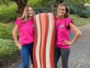 Teammates Lois Arbogast and Julia Warren, a 2003 Skyview High School graduate, pose with a giant inflatable likeness of bacon. They compete on the reboot of &quot;Supermarket Sweep,&quot; which premieres at 8 p.m. Sunday on ABC.