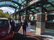 Bennye Wright of Vancouver exits the car with the help of Connie Pickering of the Human Services Council as she arrives for her appointment at The Vancouver Clinic on Wednesday afternoon. Both demand for rides and the number of volunteer drivers have been reduced during the pandemic.