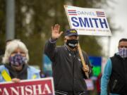 Gov. Jay Inslee waves to supporters while crossing the street at the intersection of Northeast 162nd Avenue and Northeast Fourth Plain Boulevard in Vancouver. Inslee made an appearance in Vancouver Saturday to support two Democrats -- Tanisha Harris and Daniel Smith -- running for seats in the 17th Legislative District.