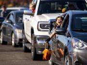 Abigail Pine, 7, screams in excitement as she sees costumed characters and goodie bags ahead of her during the fourth annual Booville, a drive-thru Halloween event put on by the Parks Foundation of Clark County at Vancouver Mall on Saturday. Abigail dressed as a kitten.