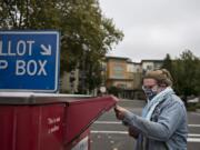 Sydney Bardurian of Vancouver makes sure her vote counts by swinging by the downtown ballot drop-off box Thursday afternoon.