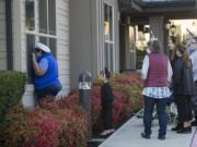 Wendy Mikota, left, of Felida pauses to brighten the day of her husband, Roger, and other residents while joining a small group of local Halloween enthusiasts Thursday during a parade around the exterior of Bonaventure of Salmon Creek. The group played recorders and kazoos, did the &quot;Hokey Pokey&quot; and sang songs to celebrate the season with residents who have been isolated because of COVID-19 concerns.