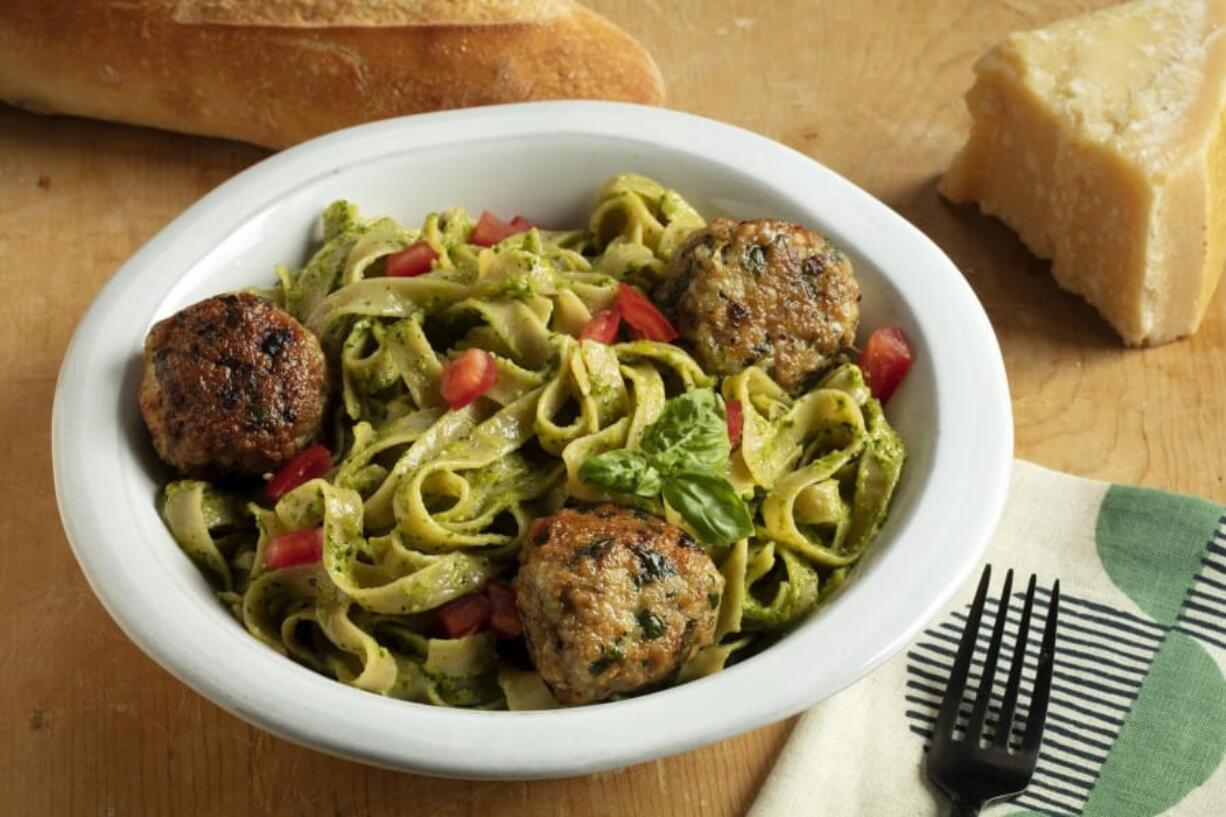 Fettucine with cilantro-almond pesto and chicken meatballs. (E.