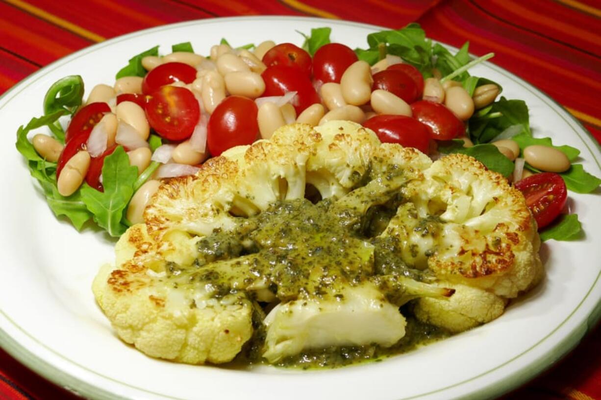 Cauliflower steak with bean and tomato salad.