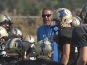 Adna football coach KC Johnson talks to his team during a preseason scrimmage in 2015. Johnson was a senior quarterback at Toledo High in 1983, when Toledo and Ridgefield played seven overtimes to set a state record.