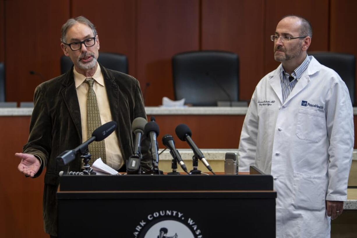 Clark County Public Health Officer Dr. Alan Melnick, left, and Dr. Lawrence Neville, chief medical officer at PeaceHealth Southwest, speak March 13 during a COVID-19 press conference at the Clark County Public Service Center. Seven months later, the pandemic is no closer to being over.