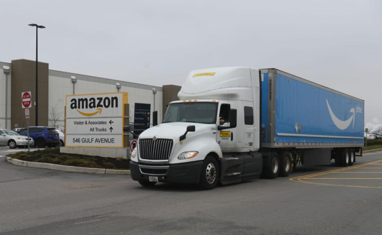 A truck is seen outside the Amazon warehouse in Staten Island as workers strike in demand that the facility be shut down and cleaned after one staffer tested positive for the coronavirus on March 30, 2020 in New York. Amazon&#039;s warehouses have more costly workplace injury claims than meatpacking or logging, Washington state says.