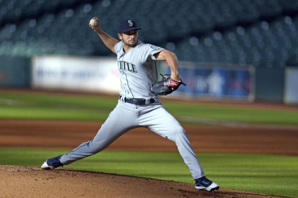 FILE - In this July 27, 2020, file photo, Seattle Mariners starting pitcher Kendall Graveman throws to a Houston Astros batter during the first inning of a baseball game in Houston. Graveman and the Mariners agreed to a $1.25 million one-year contract Thursday, Oct. 29, after the team declined his $3.5 million option in favor of a $500,000 buyout. Graveman agreed last year to a $2 million deal that included a $1.5 million salary for 2020 plus the option year. He earned $555,556 in prorated pay. (AP Photo/David J.