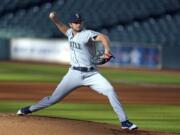 FILE - In this July 27, 2020, file photo, Seattle Mariners starting pitcher Kendall Graveman throws to a Houston Astros batter during the first inning of a baseball game in Houston. Graveman and the Mariners agreed to a $1.25 million one-year contract Thursday, Oct. 29, after the team declined his $3.5 million option in favor of a $500,000 buyout. Graveman agreed last year to a $2 million deal that included a $1.5 million salary for 2020 plus the option year. He earned $555,556 in prorated pay. (AP Photo/David J.