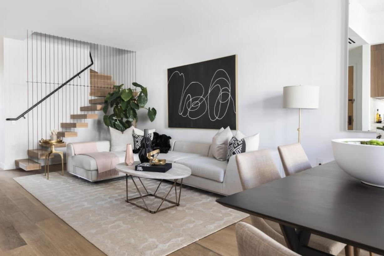 A soft pink throw paired with a vase of a similar shade serves as the perfect accent in this living space.