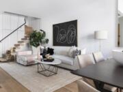 A soft pink throw paired with a vase of a similar shade serves as the perfect accent in this living space.