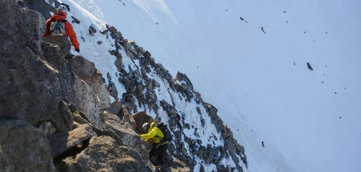 A pair of climbers trek up Mount Jefferson.