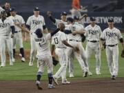 Tampa Bay Rays celebrate their victory against the Houston Astros in Game 7 of a baseball American League Championship Series, Saturday, Oct. 17, 2020, in San Diego. The Rays defeated the Astros 4-2 to win the series 4-3 games.(AP Photo/Jae C.