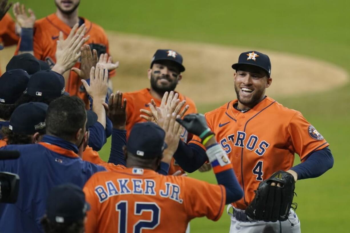 Houston Astros George Springer (4) and Jose Altuve celebrates with his teammates after winning Game 6 of a baseball American League Championship Series against the Houston Astros, Friday, Oct. 16, 2020, in San Diego. The Astros defeated the Rays 7-4 to tie the series 3-3.