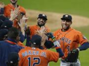 Houston Astros George Springer (4) and Jose Altuve celebrates with his teammates after winning Game 6 of a baseball American League Championship Series against the Houston Astros, Friday, Oct. 16, 2020, in San Diego. The Astros defeated the Rays 7-4 to tie the series 3-3.