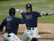 Tampa Bay Rays&#039; Michael Brosseau, right, celebrates with Yandy Diaz after hitting a solo home run during the eighth inning in Game 5 of a baseball American League Division Series against the New York Yankees, Friday, Oct. 9, 2020, in San Diego. (AP Photo/Jae C.