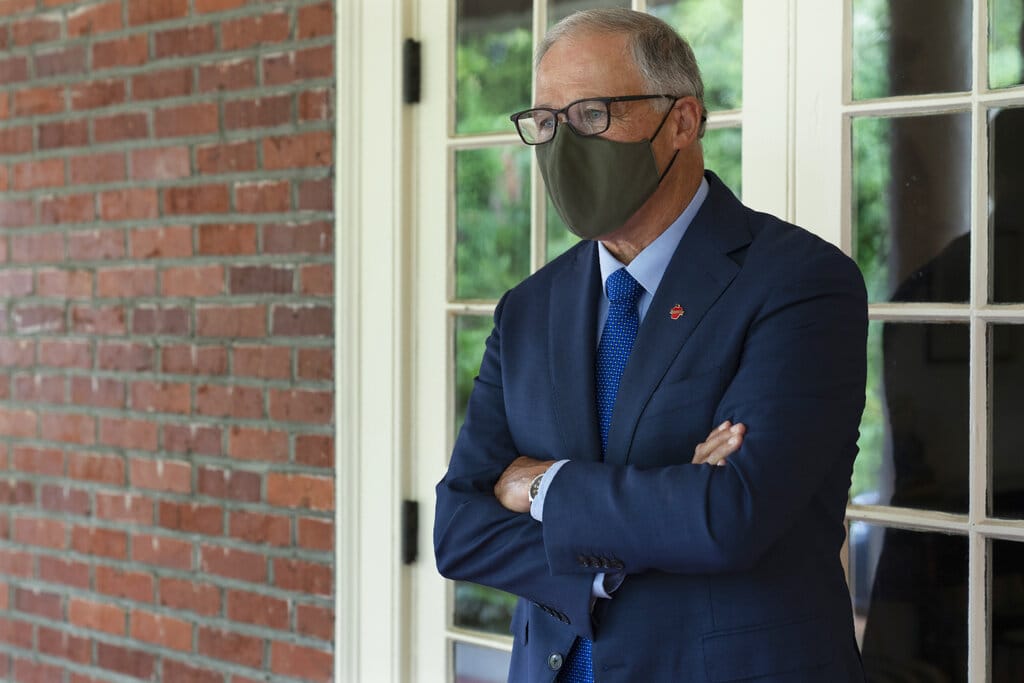 Washington Gov. Jay Inslee pauses on a walkway outside the Governor's Mansion after taking part in an AP interview, Friday, Sept. 25, 2020, in Olympia. (AP Photo/Ted S.