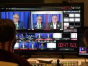 Washington gubernatorial candidates Gov. Jay Inslee, a Democrat, center-left, and Loren Culp, a Republican, center-right, are shown on a monitor in a video control room at the studios of TVW, Wednesday, Oct. 7, 2020, in Olympia, Wash., as they take part in a debate. Due to concerns over COVID-19, each candidate took part in the debate from individual rooms separate from moderators. (AP Photo/Ted S.