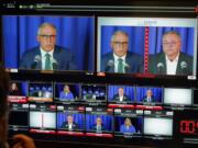 Washington gubernatorial candidates Gov. Jay Inslee, a Democrat, left, and Loren Culp, a Republican, right, are shown on a monitor in a video control room at the studios of TVW, Wednesday, Oct. 7, 2020, in Olympia, Wash., as they take part in a debate. Due to concerns over COVID-19, each candidate took part in the debate from individual rooms separate from moderators. (AP Photo/Ted S.