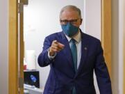 Washington Gov. Jay Inslee, a Democrat, points to a member of his team after taking part in a debate with Loren Culp, a Republican, Wednesday, Oct. 7, 2020, in Olympia, Wash. Due to concerns over COVID-19, each candidate took part in the debate from an individual room, separate from moderators. (AP Photo/Ted S.