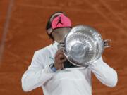 Spain's Rafael Nadal holds the trophy as he celebrates winning the final match of the French Open tennis tournament against Serbia's Novak Djokovic in three sets, 6-0, 6-2, 7-5, at the Roland Garros stadium in Paris, France, Sunday, Oct. 11, 2020.